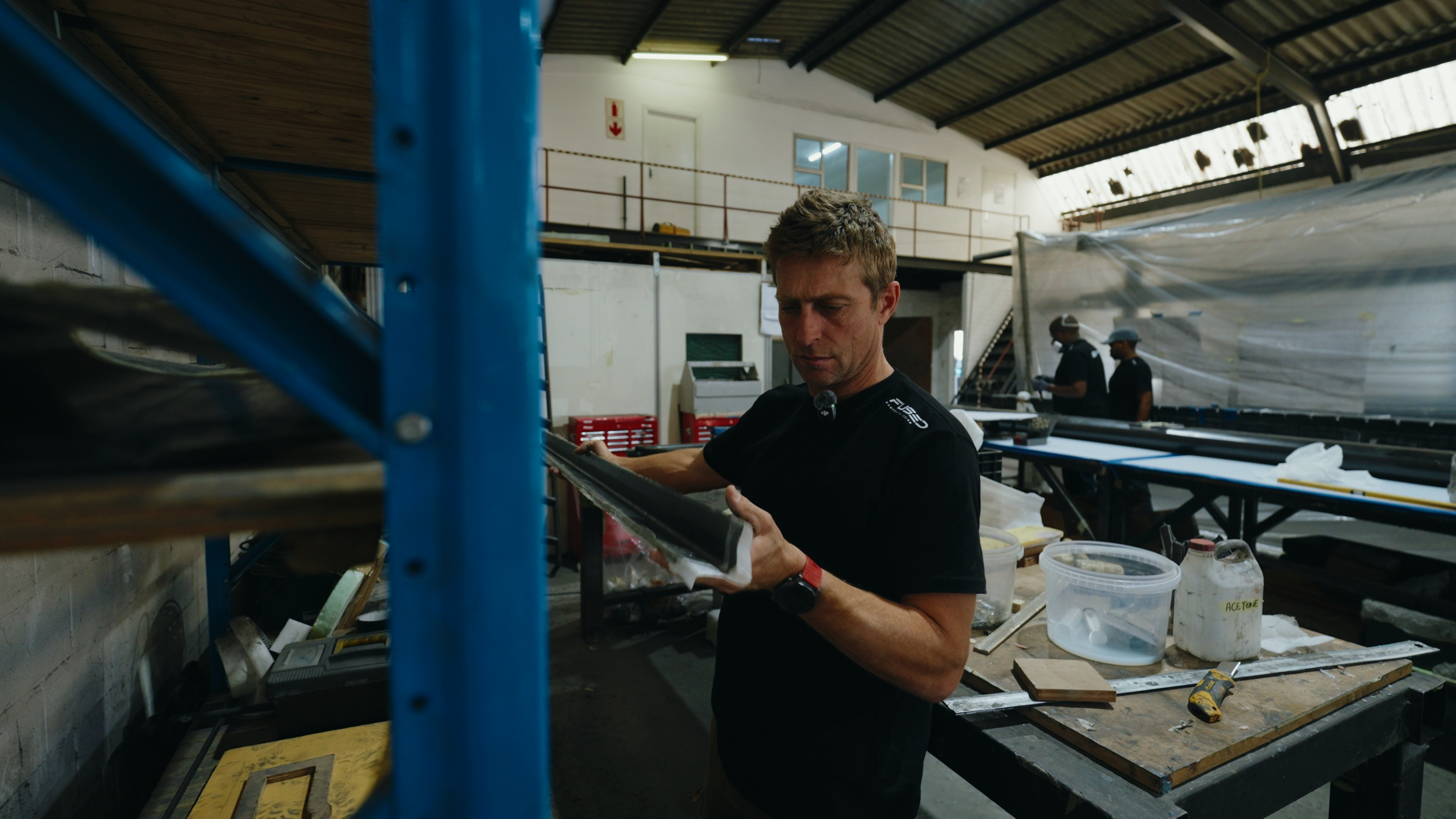 Technician sighting along a carbon section at the bench