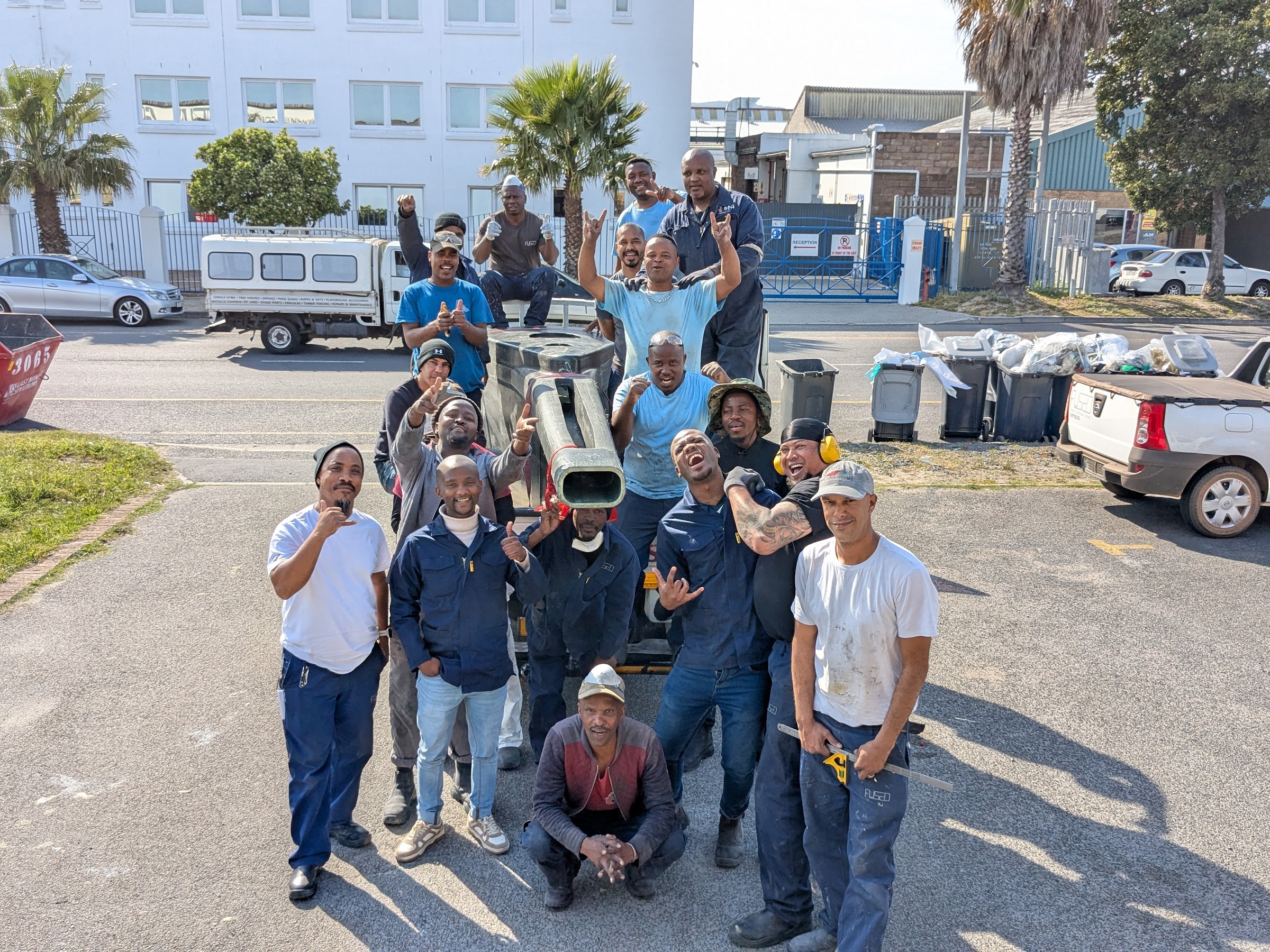 The FCD workshop team outside the factory with a finished component