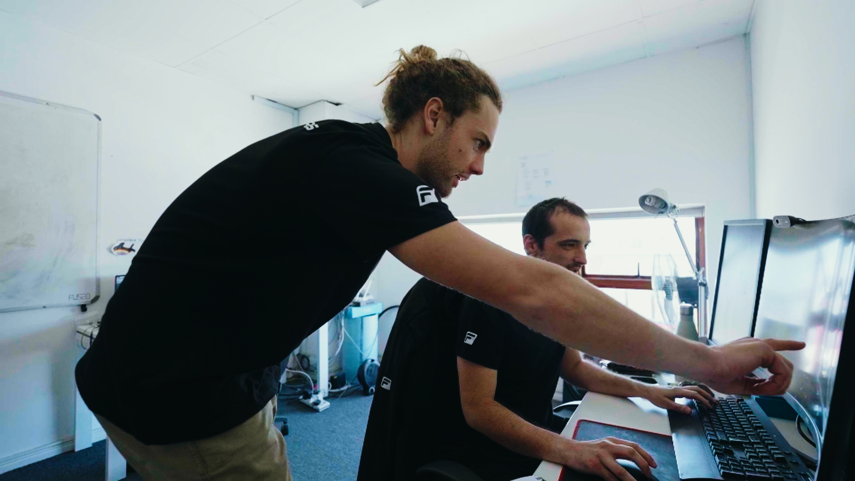 Two FCD engineers reviewing a boom model on screen