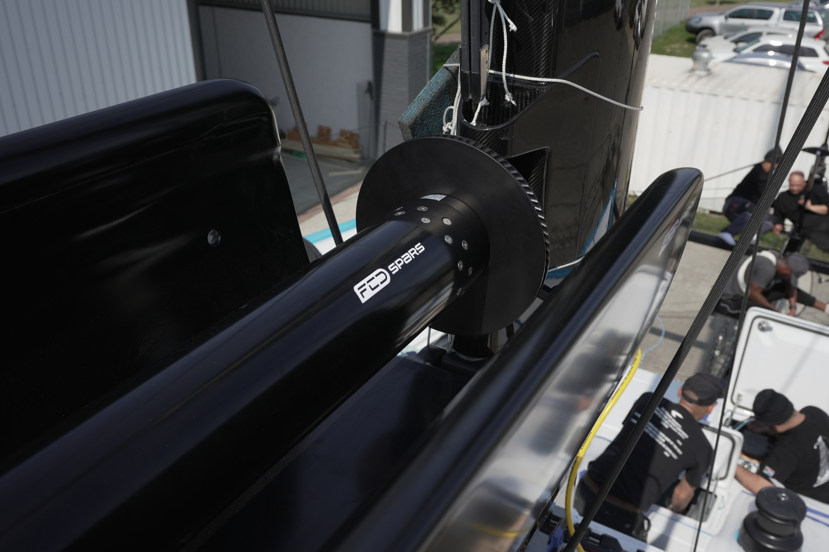 Furling drive and mandrel bearing at the forward end of a gloss black FCD Spars boom