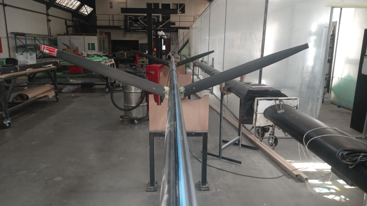 Carbon mast with spreaders fitted, laid along the FCD workshop