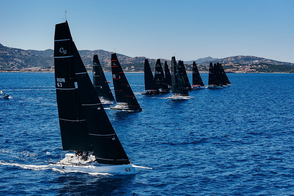 Fleet of Cape 31s on a start line under black carbon rigs
