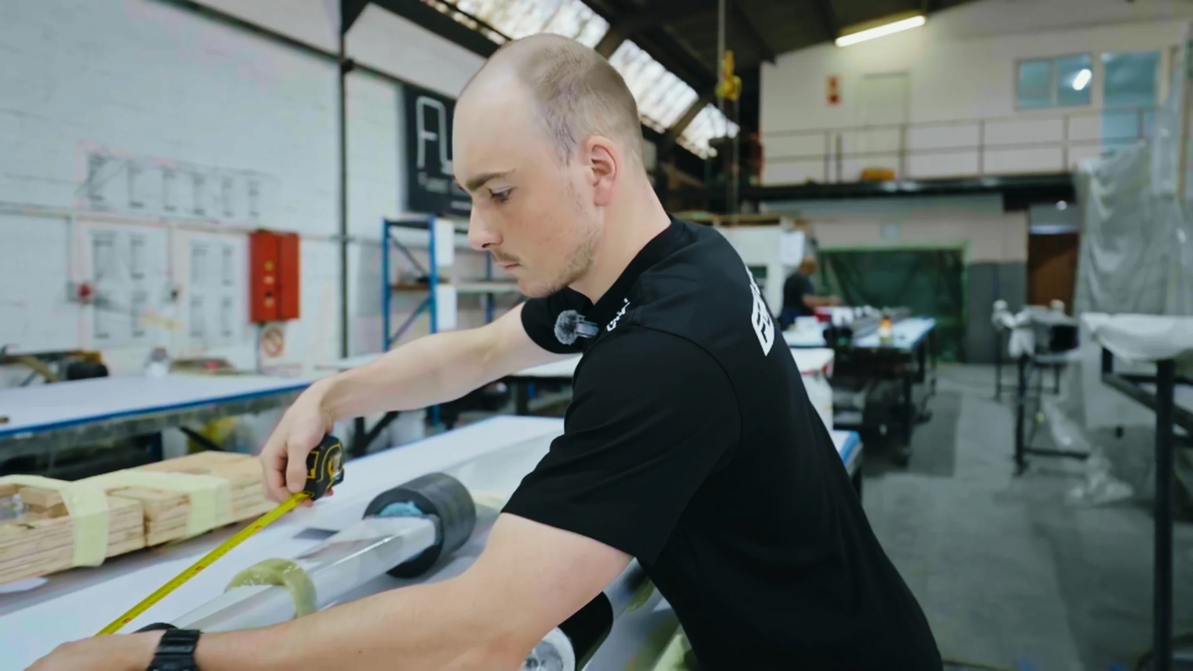 Technician inspecting a composite component in the workshop